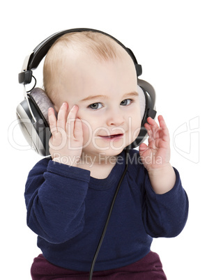 young child with ear-phones listening to music