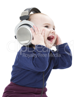 young laughing child with ear-phones listening to music