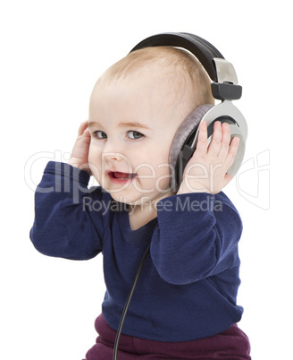 young child with ear-phones listening to music