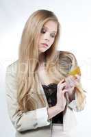 blond woman holding a golden credit card