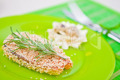 fish with sesame on a green plate