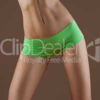 Beauty and perfect woman with ideal fitness body in green pantie