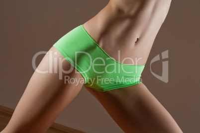 Beauty and perfect woman with ideal fitness body in green pantie