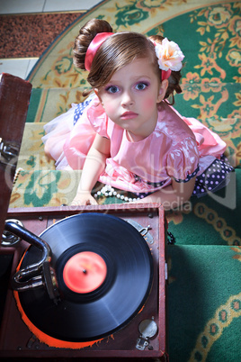 Girl in pink with a gramophone.