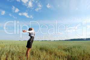Attractive happy young woman in the field