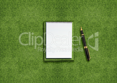 Blank notebook on grass