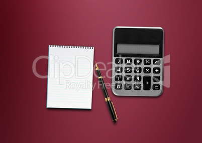 calculator, a pen and blank paper on the table