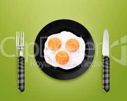 Three fried eggs on a Plate