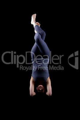 Woman - dark dress stand on hands in yoga pose