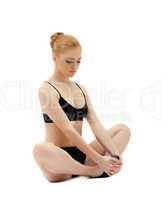 Cute blond girl sit in yoga training pose isolated
