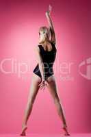 Sexy blond woman sport black dress on pink