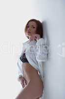 Beauty young woman in sexy shirt on white wall