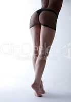 Beauty woman naked legs in dark lingerie