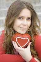 Attractive woman holding a red heart