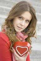Attractive woman holding a red heart