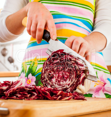 Woman's hands cutting red cabbage