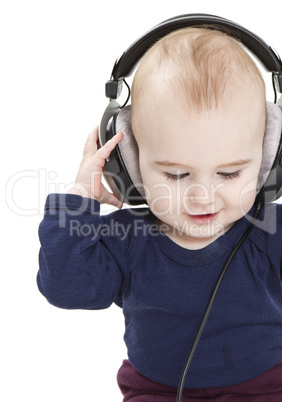 young child with ear-phones listening to music