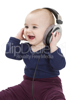 young child with ear-phones listening to music