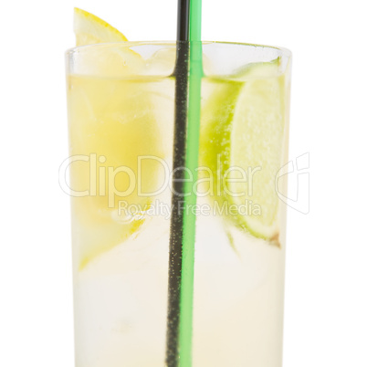 A delicious cocktail with slices of lemon and lime in a glass be