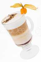 A delicious latte in a glass beaker decorated with cape gooseber