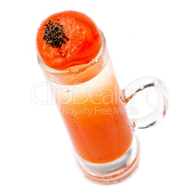 A delicious shot with cherry tomato and pepper on top