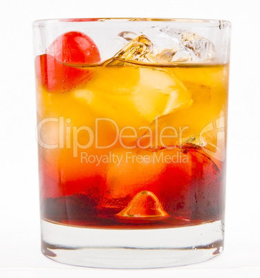 A delicious glass of whiskey with ice cubes and cherry