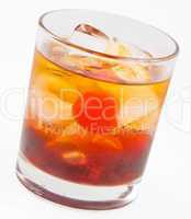 A delicious glass of whiskey with ice cubes and cherry