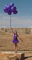 Pretty little girl with baloons in hand