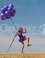 Pretty little girl with baloons in hand