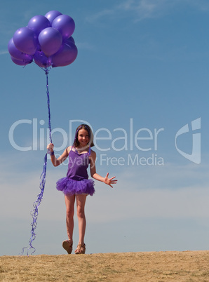 Pretty little girl with baloons in hand