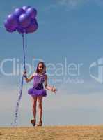 Pretty little girl with baloons in hand