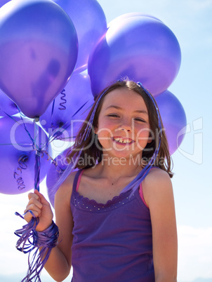 Pretty little girl with baloons in hand