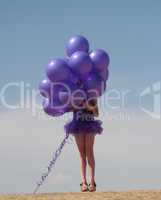 Pretty little girl with baloons in hand