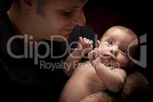 Young Father Holding His Mixed Race Newborn Baby