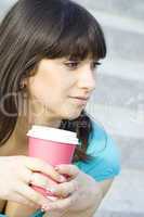 Female in a park drinking coffee