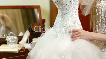 DOLLY: Bride Trying On A Wedding Dress