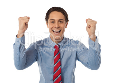 Businessman celebrating success with arms raised