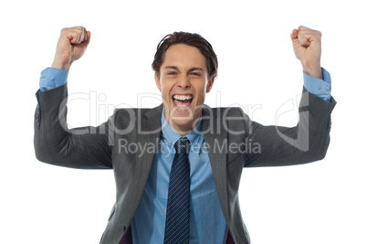 Excited businessman rasing his arms and cheering joyfully