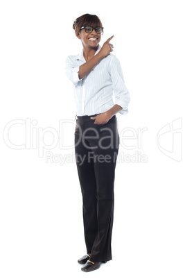 Corporate smiling woman pointing away