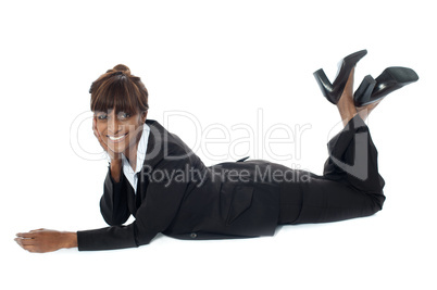 Corporate woman lying on floor, smiling