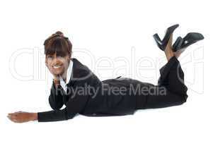 Corporate woman lying on floor, smiling