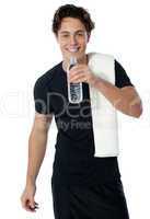 Fit man drinking water isolated on white