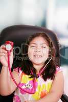 Cute little girl is playing doctor with stethoscope, isolated ov