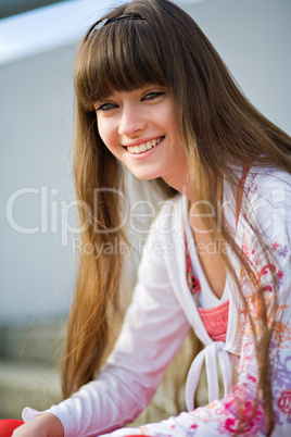 A beautiful girl with long hair coquettishly smiling