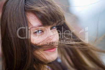 A beautiful girl with long hair coquettishly smiling