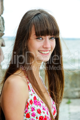 A beautiful girl with long hair coquettishly smiling