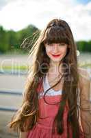 A beautiful girl with long hair coquettishly smiling