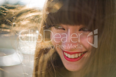 A beautiful girl with long hair coquettishly smiling