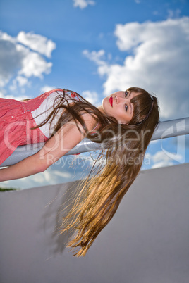 A beautiful girl with long hair coquettishly smiling