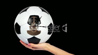 Soccer Ball Clock on the hand, on the black background, Timelapse